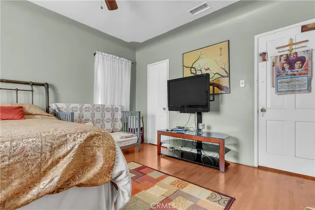 a bedroom with a bed and a flat screen tv