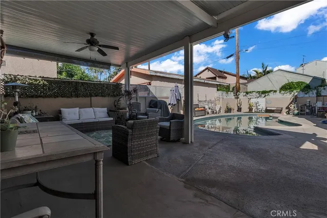 a view of a patio with table and chairs potted plants with wooden floor