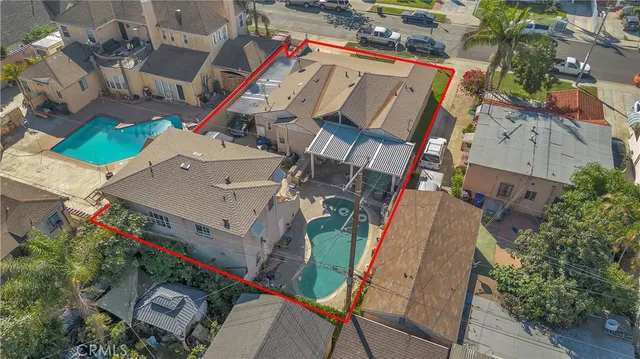 an aerial view of a house with a yard and potted plants