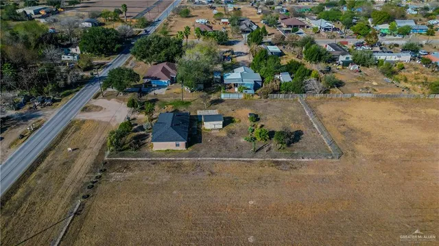 an aerial view of a house with a yard and lake view