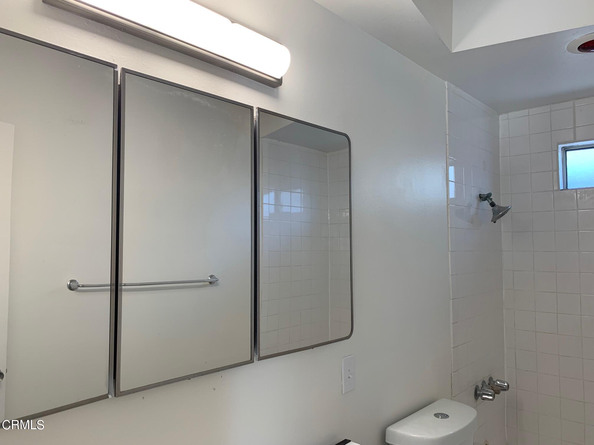 1746 Atchison Street Pasadena, CA 91104 - Photo 17 of 22 a bathroom with a granite countertop sink and mirror