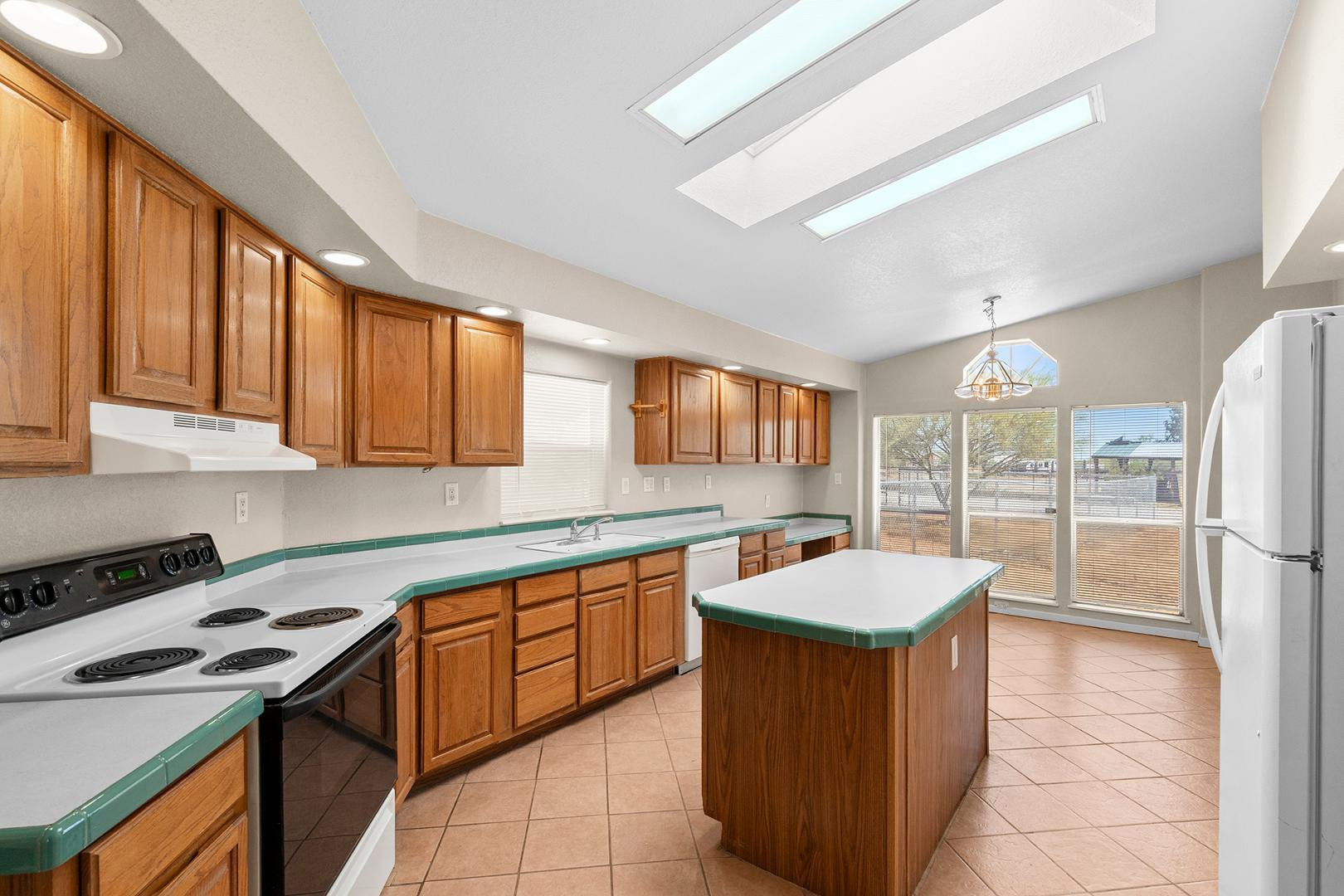 37408 North 20th Street Phoenix, AZ 85086 - Photo 13 of 28 a large kitchen with stainless steel appliances granite countertop a stove a sink dishwasher and a refrigerator
