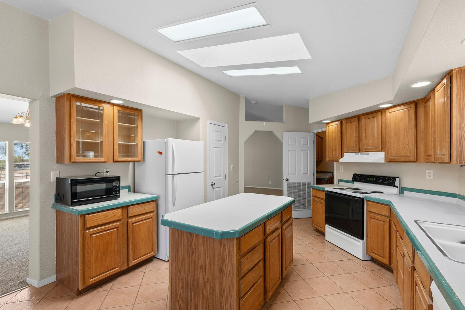 37408 North 20th Street Phoenix, AZ 85086 - Photo 9 of 28 a kitchen with a stove a sink and a refrigerator