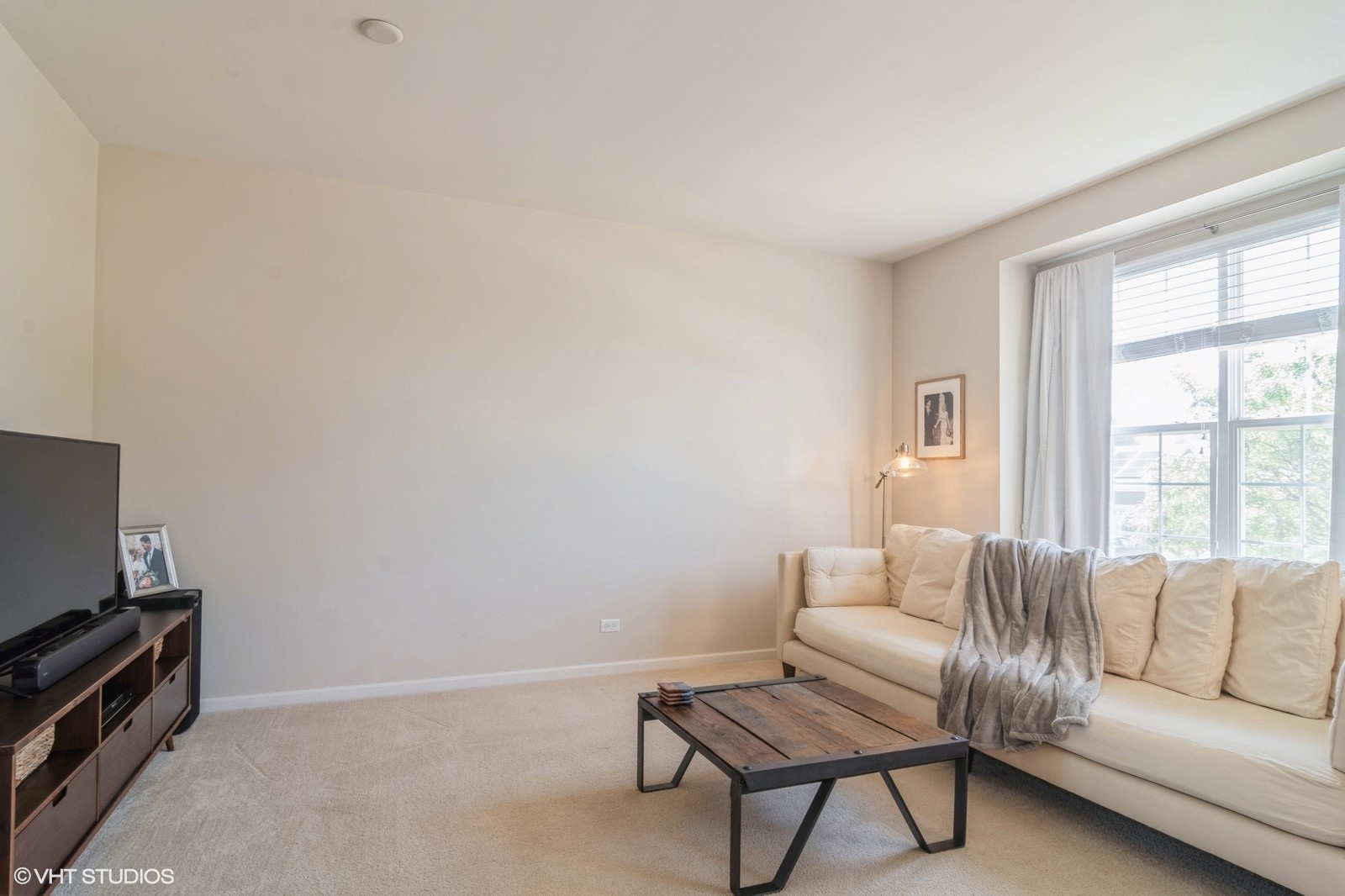 4072 Pompton Avenue Elgin, IL 60124 - Photo 2 of 13 a living room with furniture a flat screen tv and a window