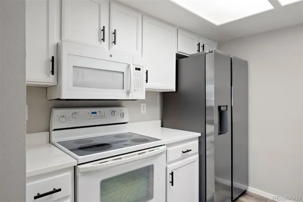 a kitchen with appliances cabinets and a counter top space