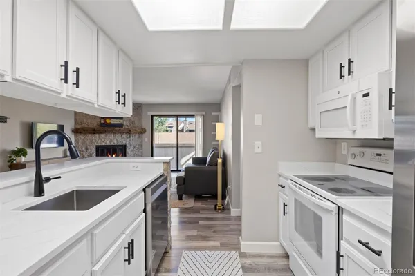 a kitchen with a sink cabinets and appliances