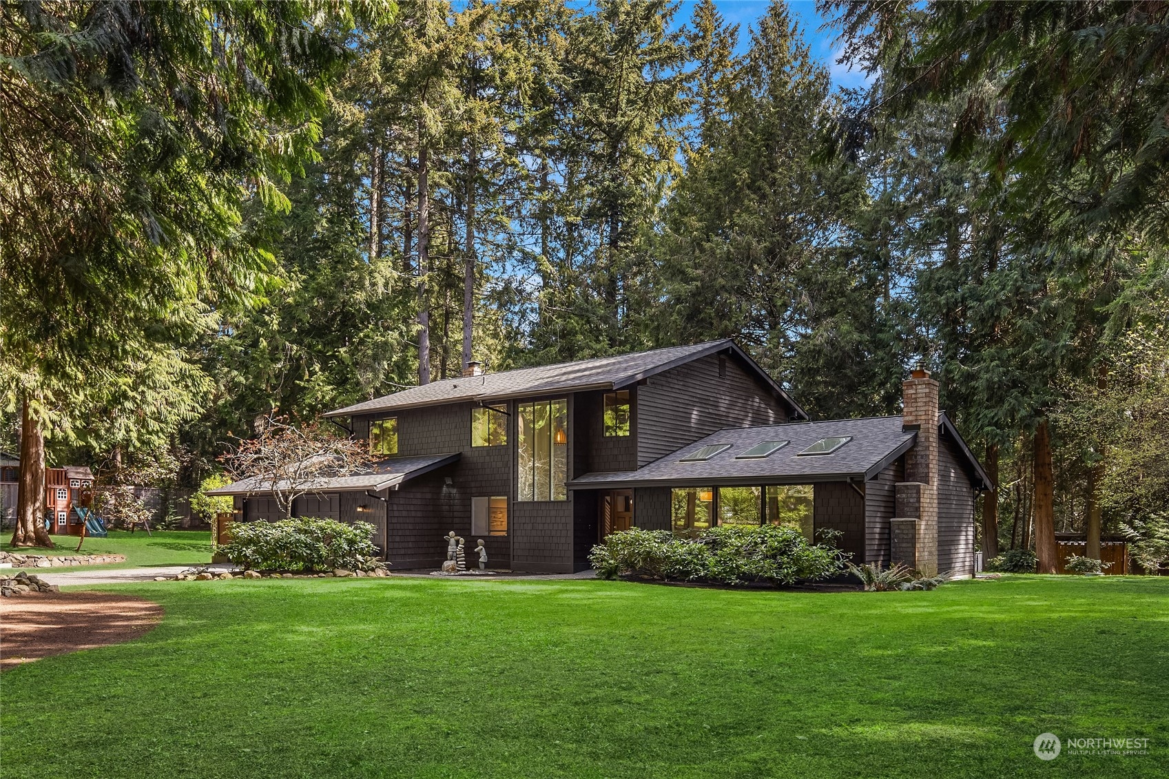 6322 Lariat Loop Bainbridge Island, WA 98110 - Photo 2 of 40 a front view of a house with a garden
