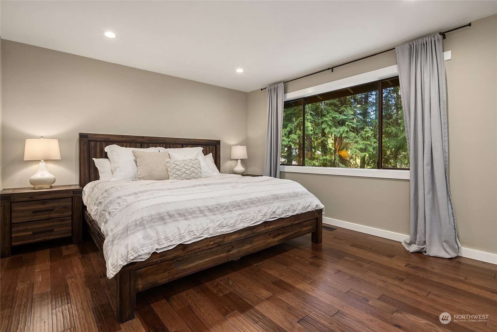 6322 Lariat Loop Bainbridge Island, WA 98110 - Photo 23 of 40 a bedroom with a bed and a large window