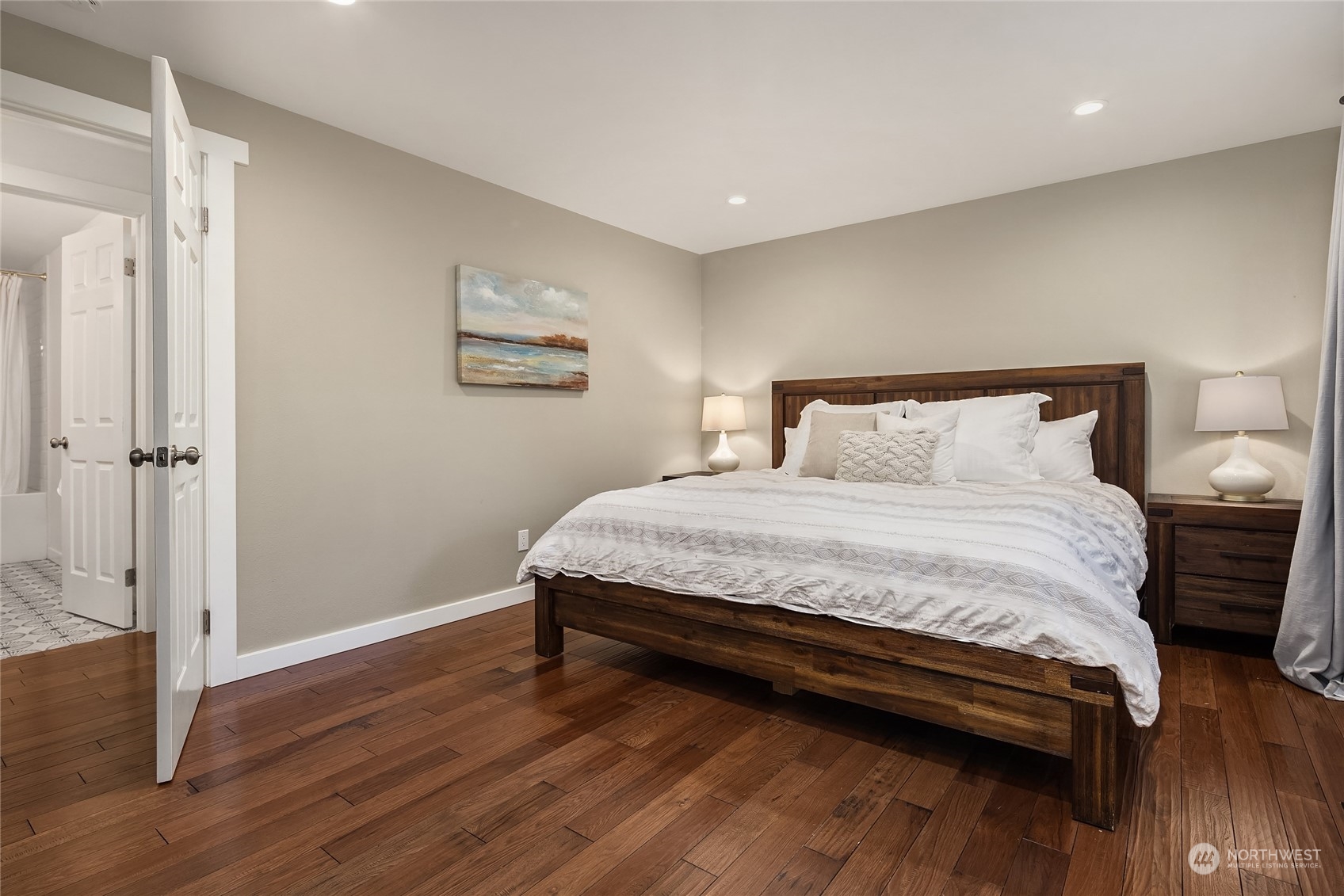 6322 Lariat Loop Bainbridge Island, WA 98110 - Photo 24 of 40 a bedroom with a bed and wooden floor
