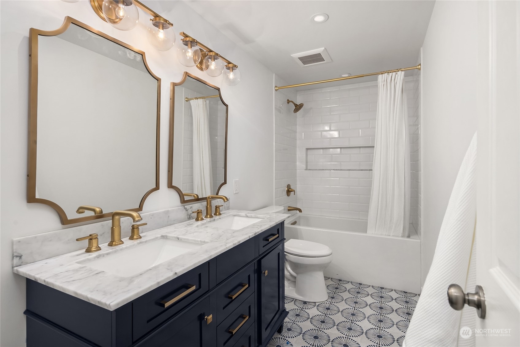 6322 Lariat Loop Bainbridge Island, WA 98110 - Photo 30 of 40 a bathroom with a sink a toilet a mirror and shower