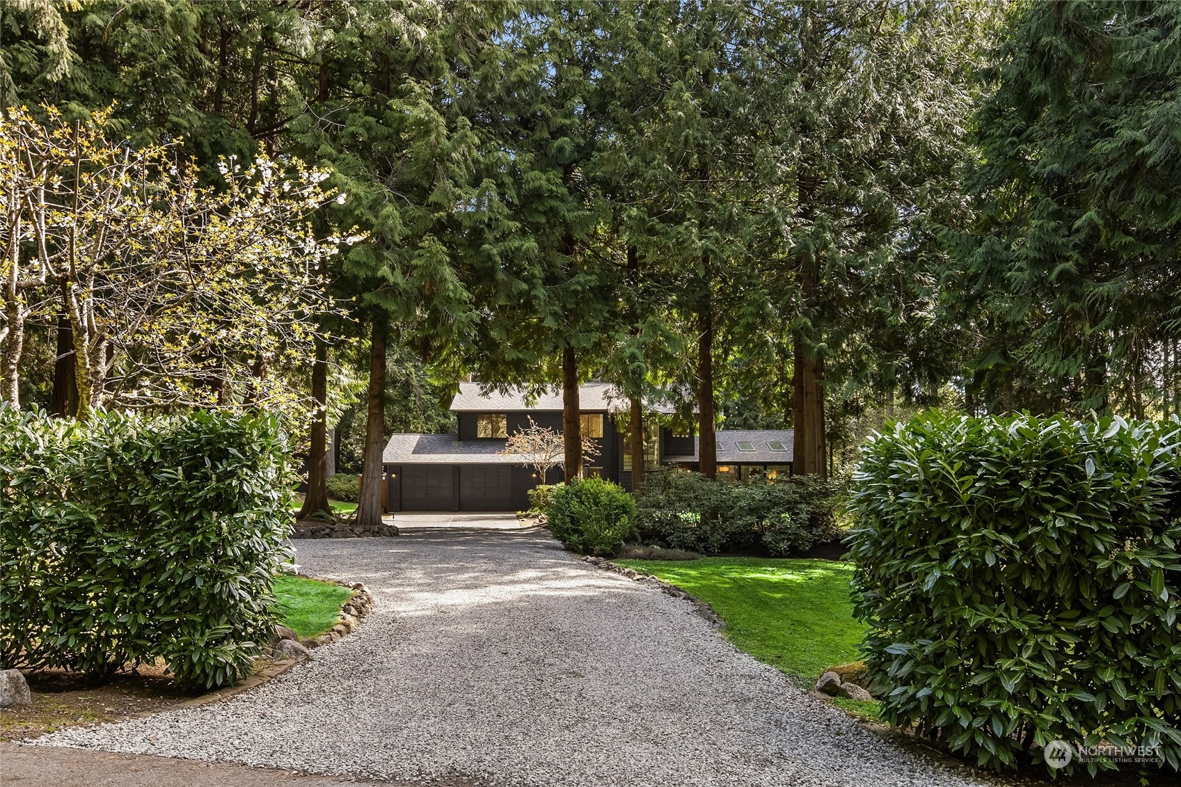 6322 Lariat Loop Bainbridge Island, WA 98110 - Photo 32 of 40 a front view of a house with a yard and shrubs