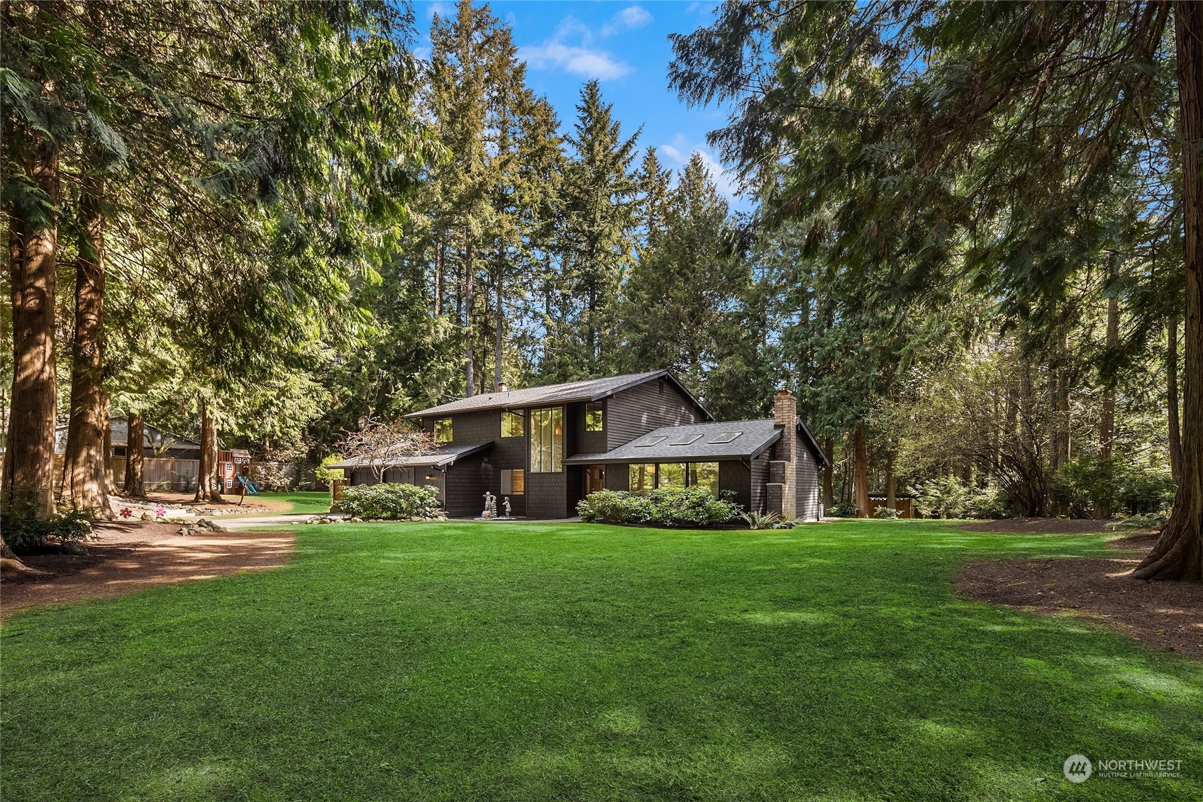 6322 Lariat Loop Bainbridge Island, WA 98110 - Photo 33 of 40 a front view of a house with garden