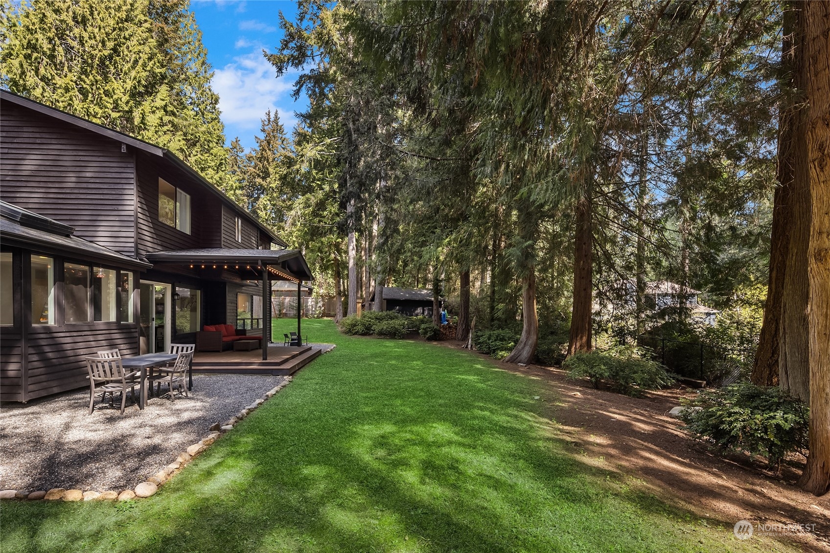 6322 Lariat Loop Bainbridge Island, WA 98110 - Photo 36 of 40 a backyard of a house with table and chairs
