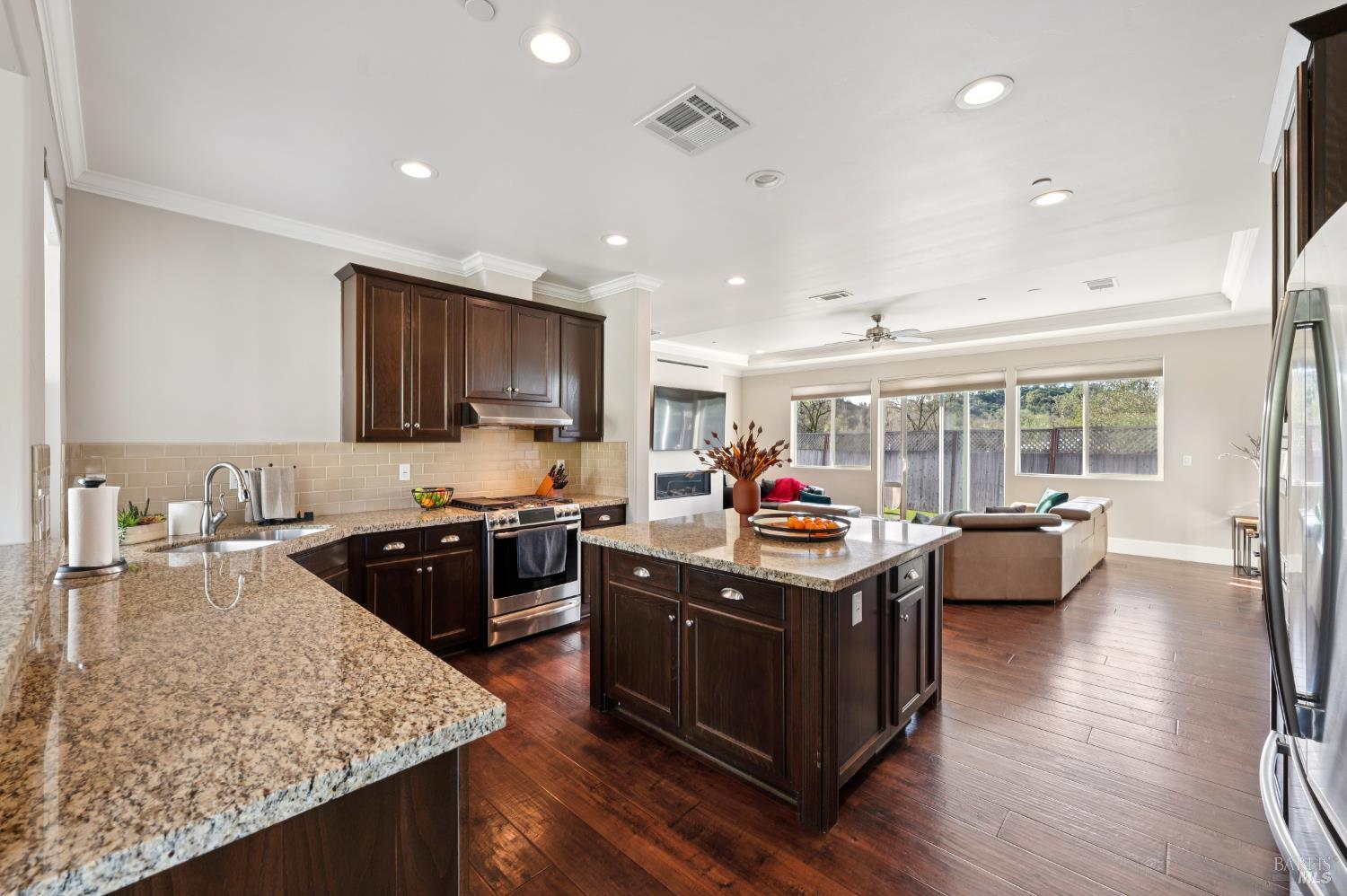 1840-1850 Riebli Road Santa Rosa, CA 95404 - Photo 30 of 71 a kitchen with kitchen island granite countertop wooden floors and stainless steel appliances