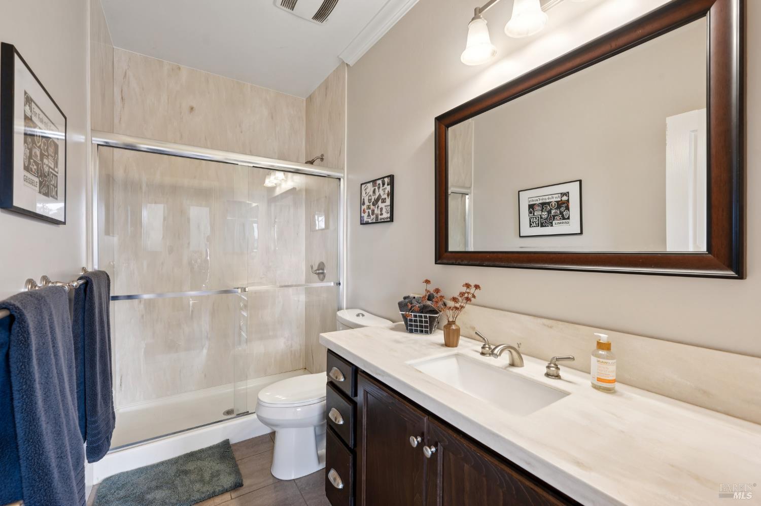 1840-1850 Riebli Road Santa Rosa, CA 95404 - Photo 37 of 71 a bathroom with a double vanity sink toilet mirror and shower