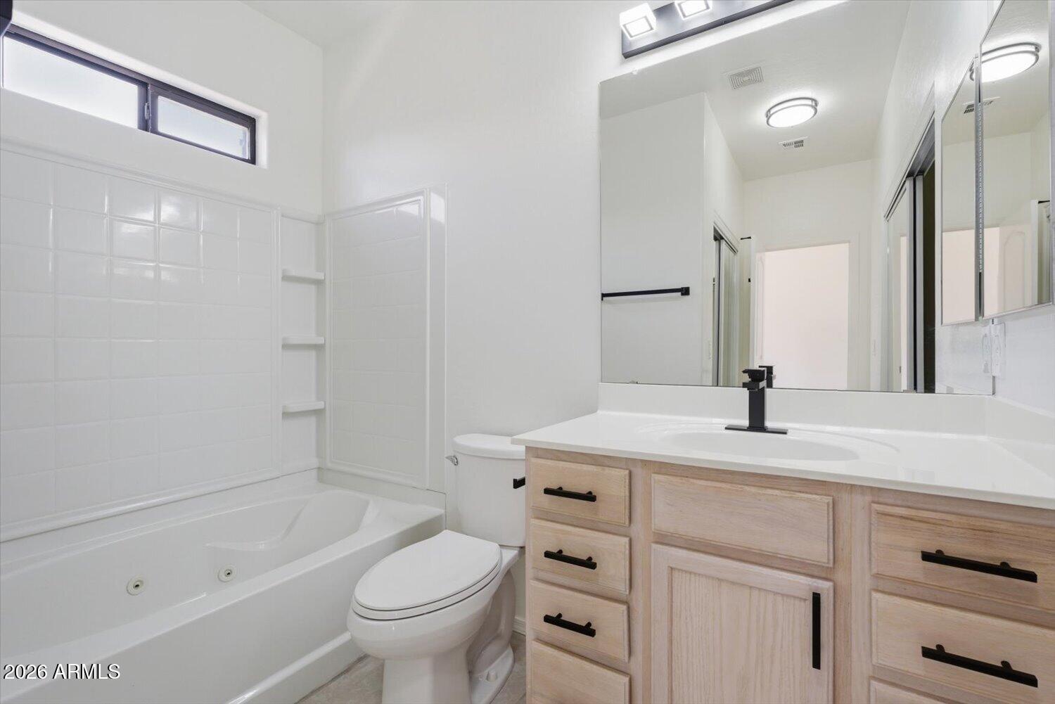 2565 South Signal Butte Road, Unit 23 Mesa, AZ 85209 - Photo 17 of 29 a bathroom with a sink a toilet and a large mirror
