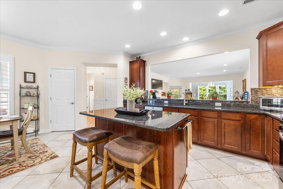 2056 Kennedy Drive Fort Mill, SC 29707 - Photo 17 of 45 a kitchen with stainless steel appliances granite countertop table chairs sink and cabinets