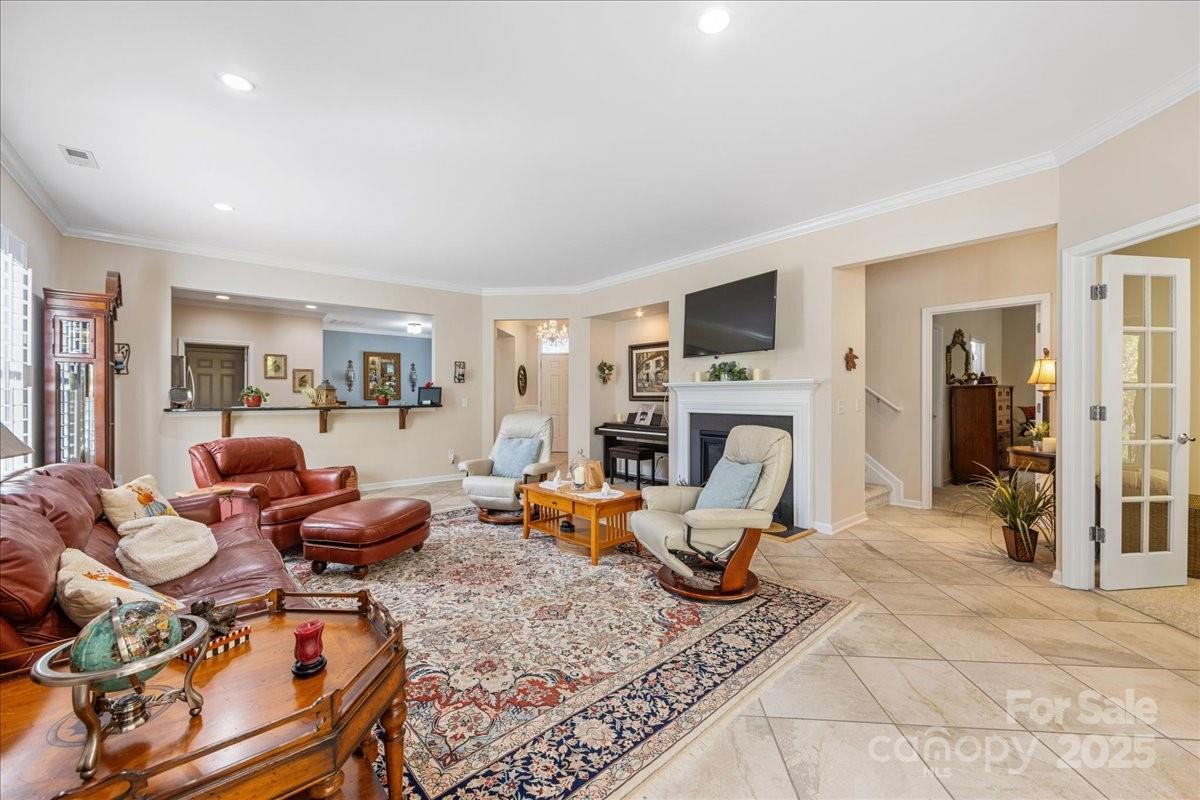 2056 Kennedy Drive Fort Mill, SC 29707 - Photo 22 of 45 a living room with furniture a fireplace and a flat screen tv