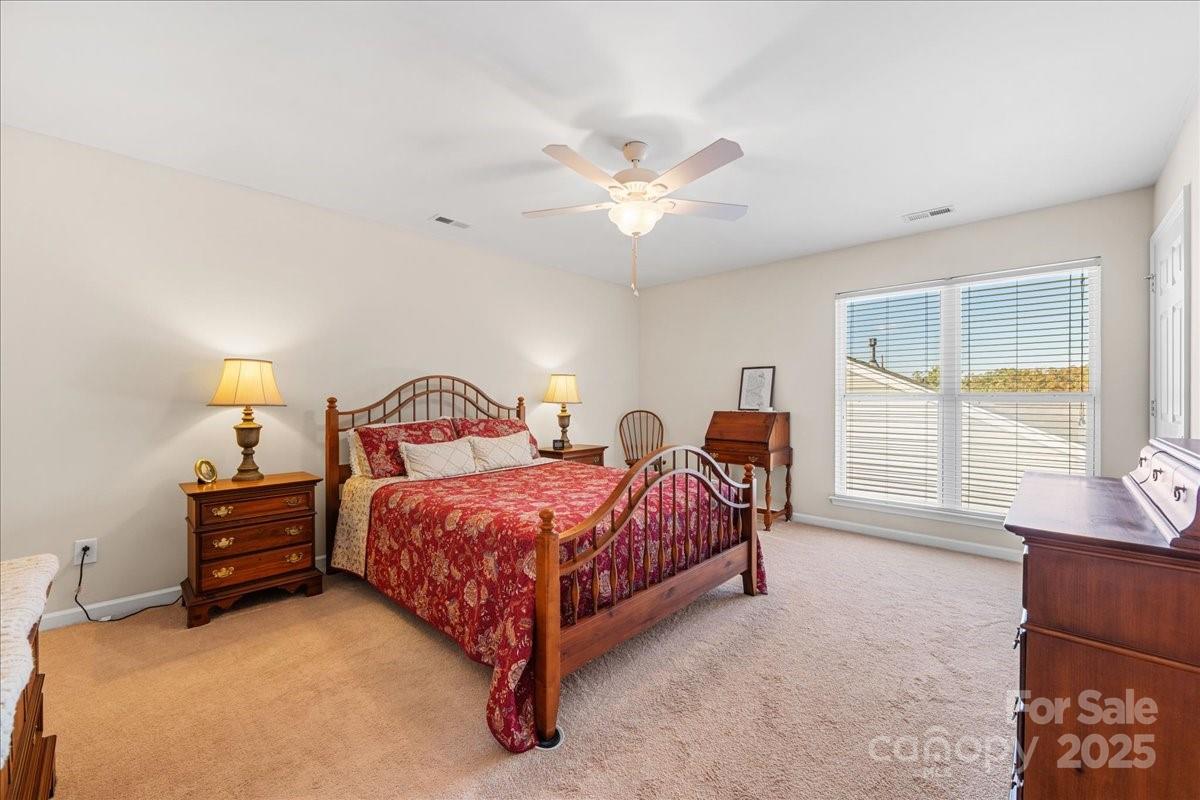 2056 Kennedy Drive Fort Mill, SC 29707 - Photo 32 of 45 a spacious bedroom with a bed and a large window