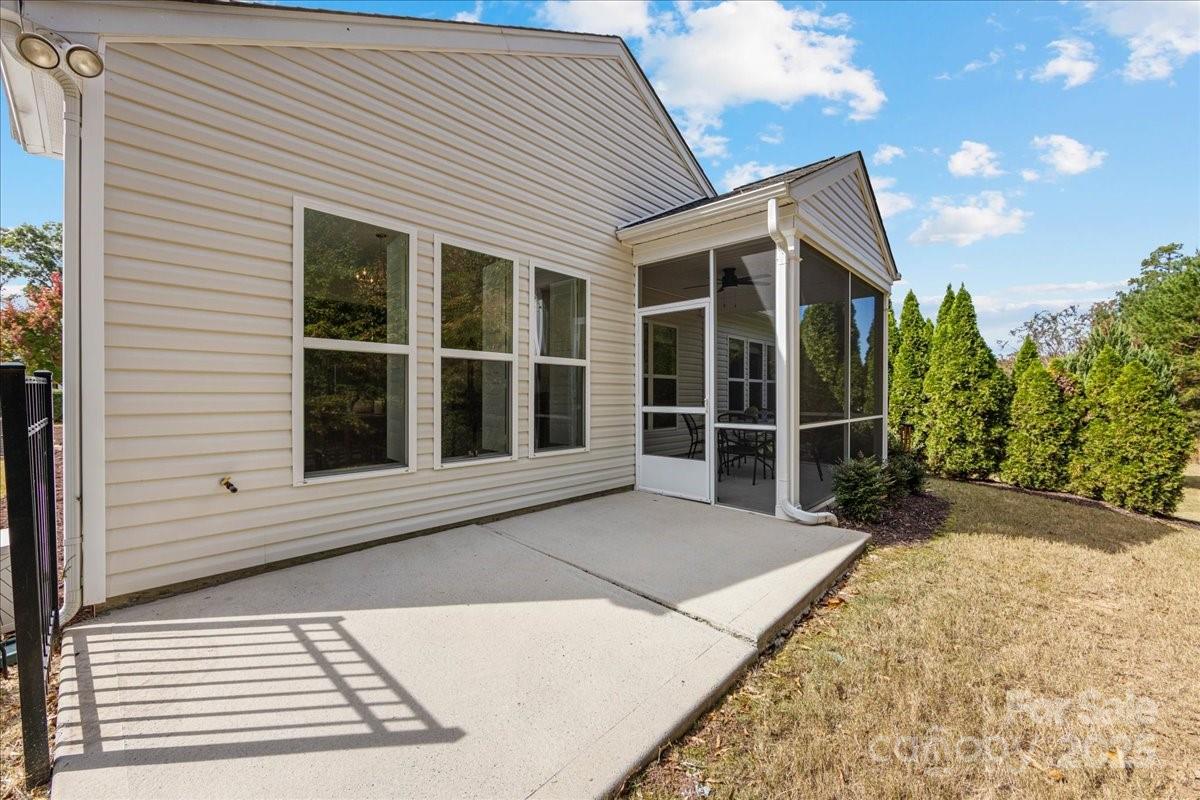 2056 Kennedy Drive Fort Mill, SC 29707 - Photo 34 of 45 a view of a house with a large window and wooden fence