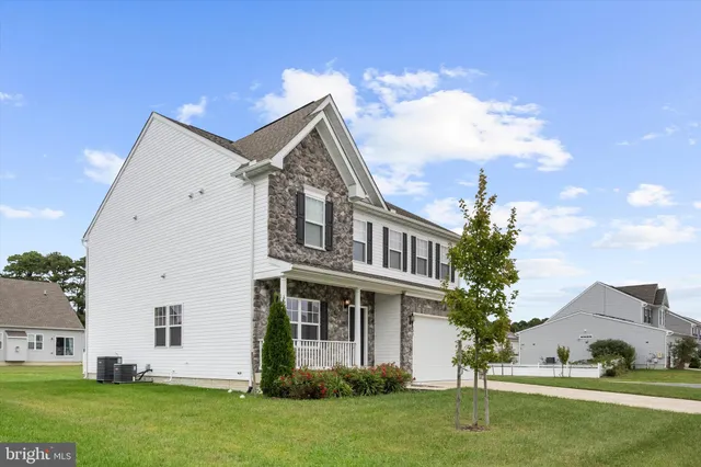 a view of house with garden and entertaining space