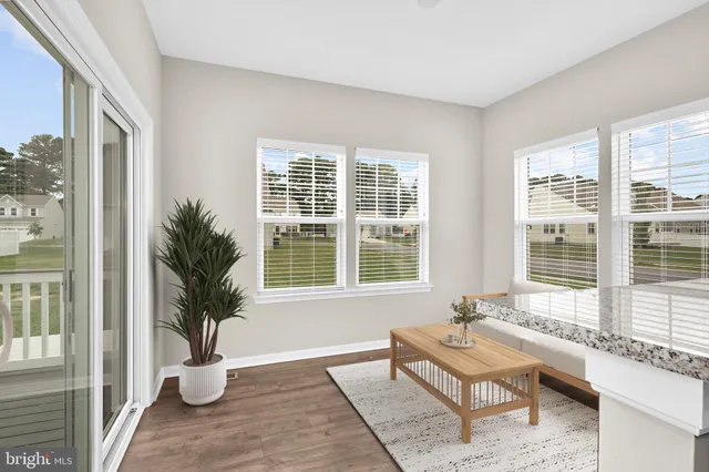 a living room with furniture and next to a window