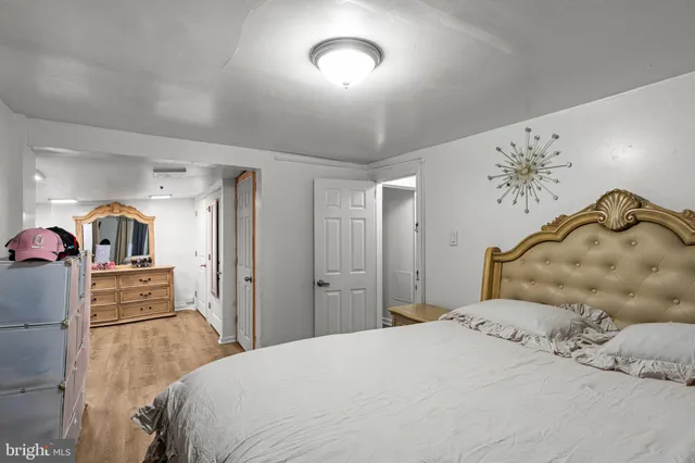 a bedroom with a bed and a night stand