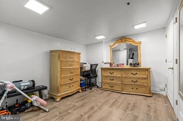 a room with a dresser and a mirror