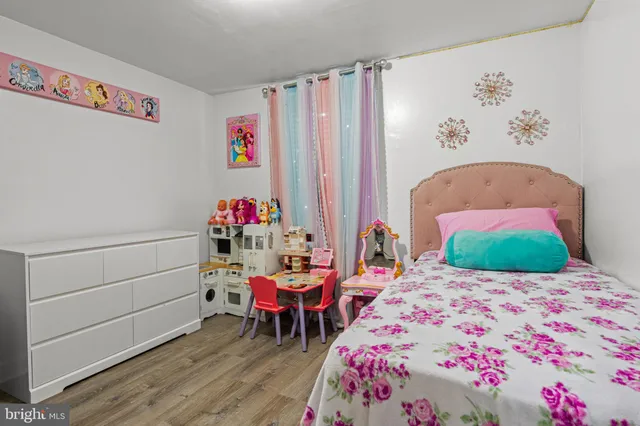 a bedroom with a bed and a workspace