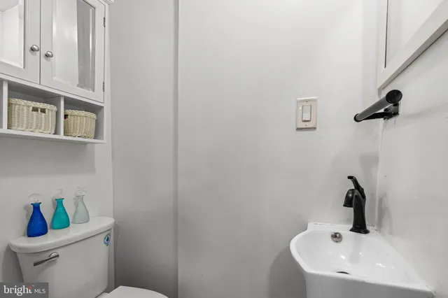 a bathroom with a sink a toilet and mirror