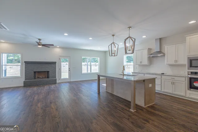 an open kitchen with sink and cabinets