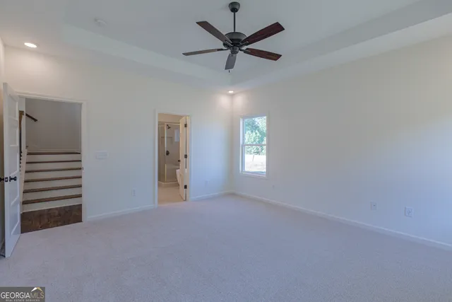 a view of a livingroom with a ceiling fan and window