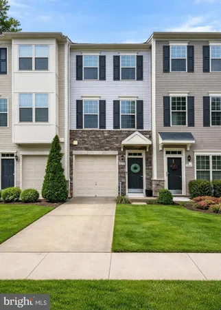 a front view of a building with a yard