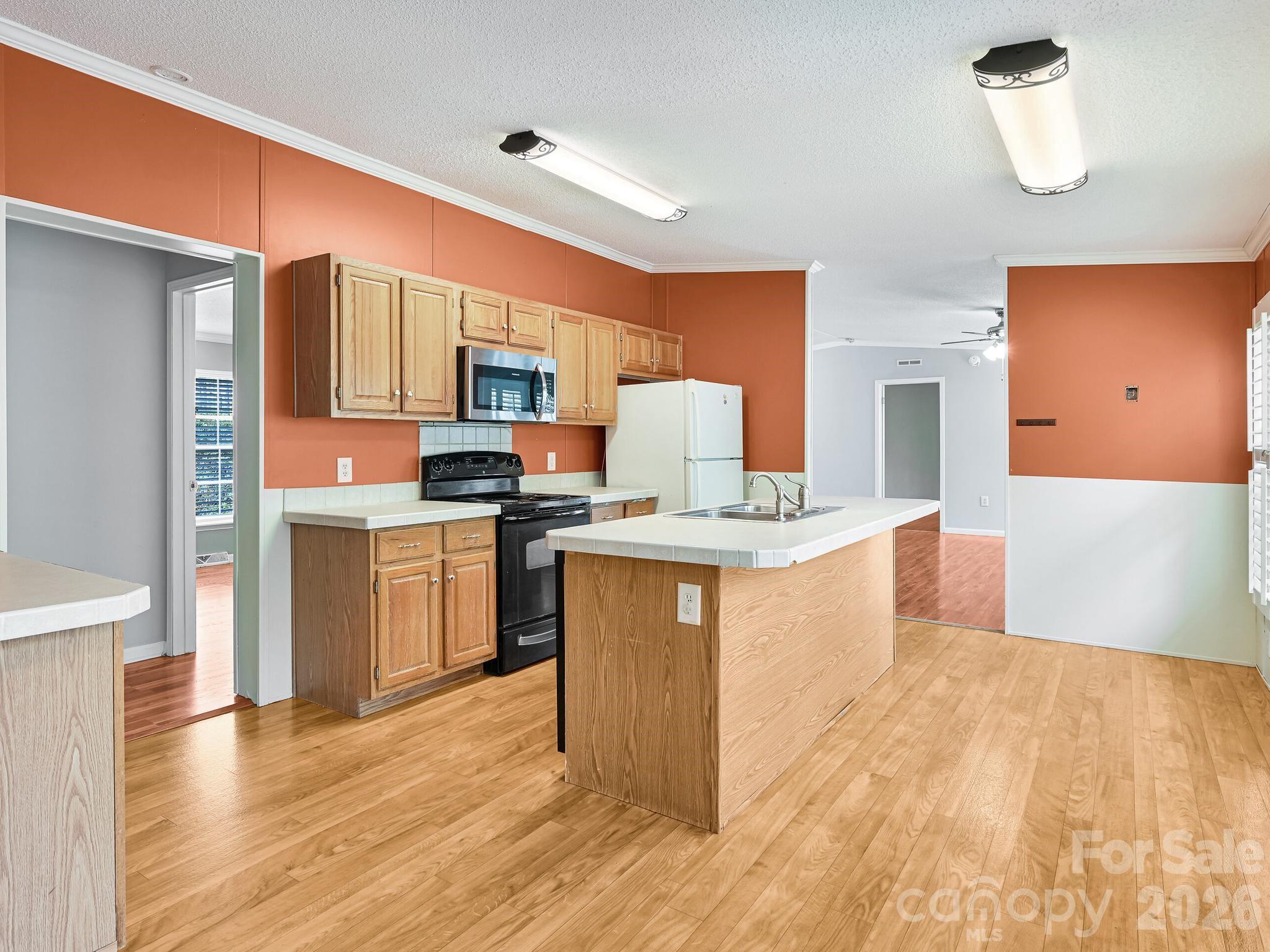 119 Laurel Haven Road Fairview, NC 28730 - Photo 22 of 33 a kitchen with a sink cabinets and wooden floor