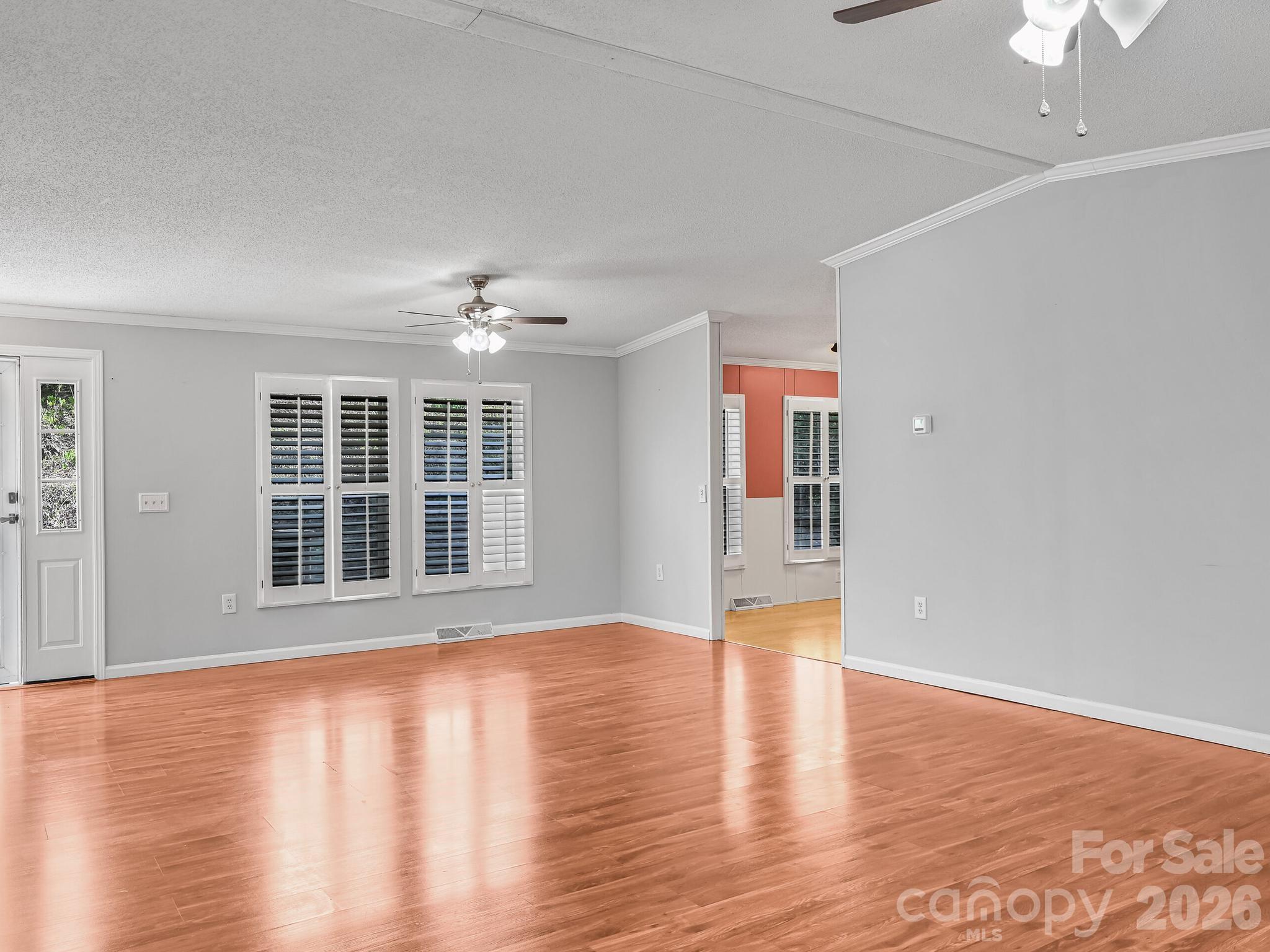 119 Laurel Haven Road Fairview, NC 28730 - Photo 9 of 33 a view of an empty room with wooden floor and a window