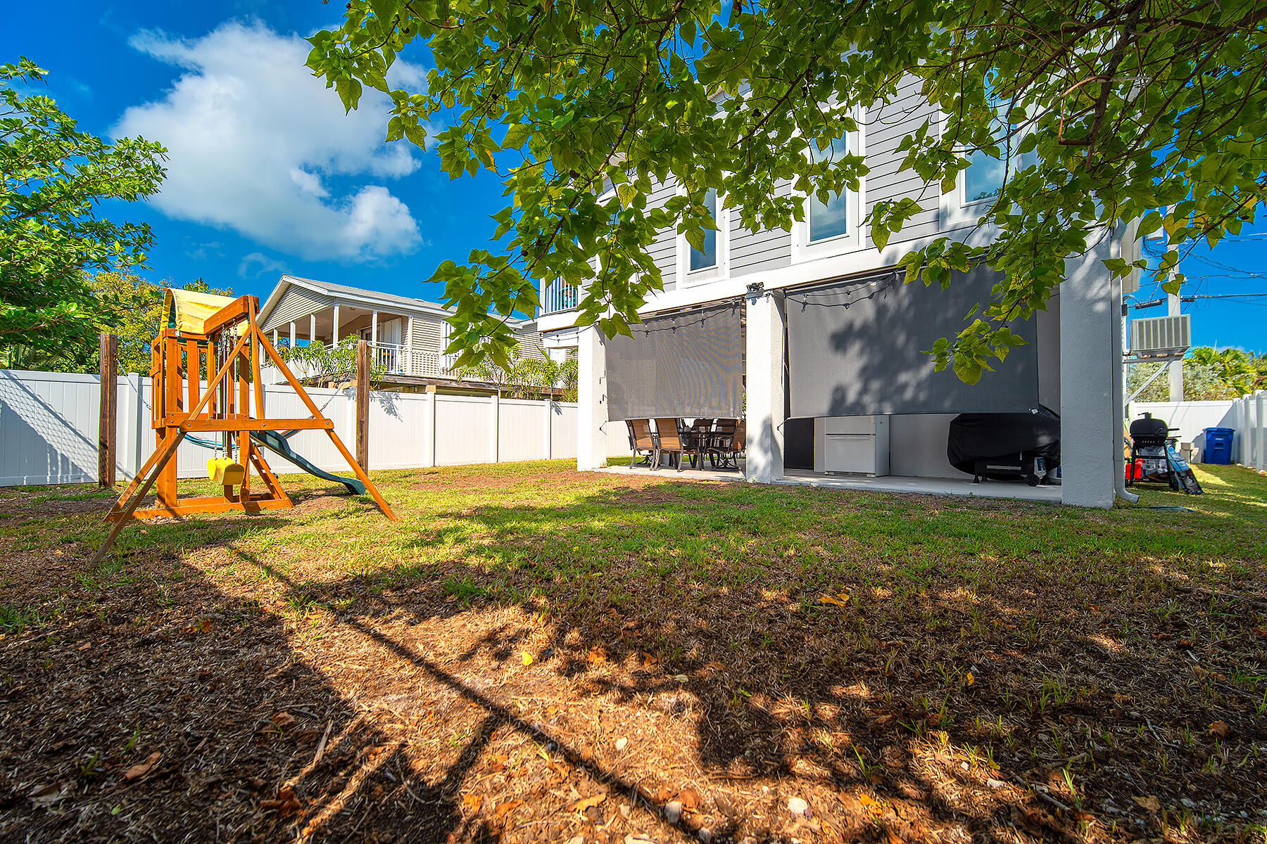 10 Riviera Drive Key West, FL 33040 - Photo 45 of 49 a backyard of a house with table and chairs