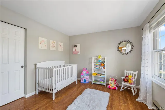 a bedroom with bed and a wooden floor