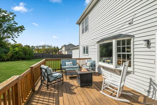 a view of a chairs and table on the deck