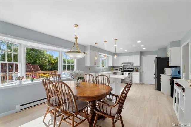 a dining room with furniture a chandelier and window