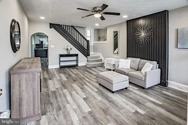 a living room with furniture and a wooden floor