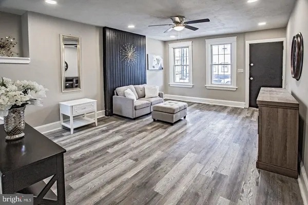 a living room with furniture and wooden floor