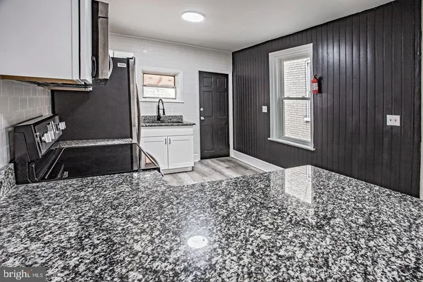 a view of a refrigerator in kitchen and living room