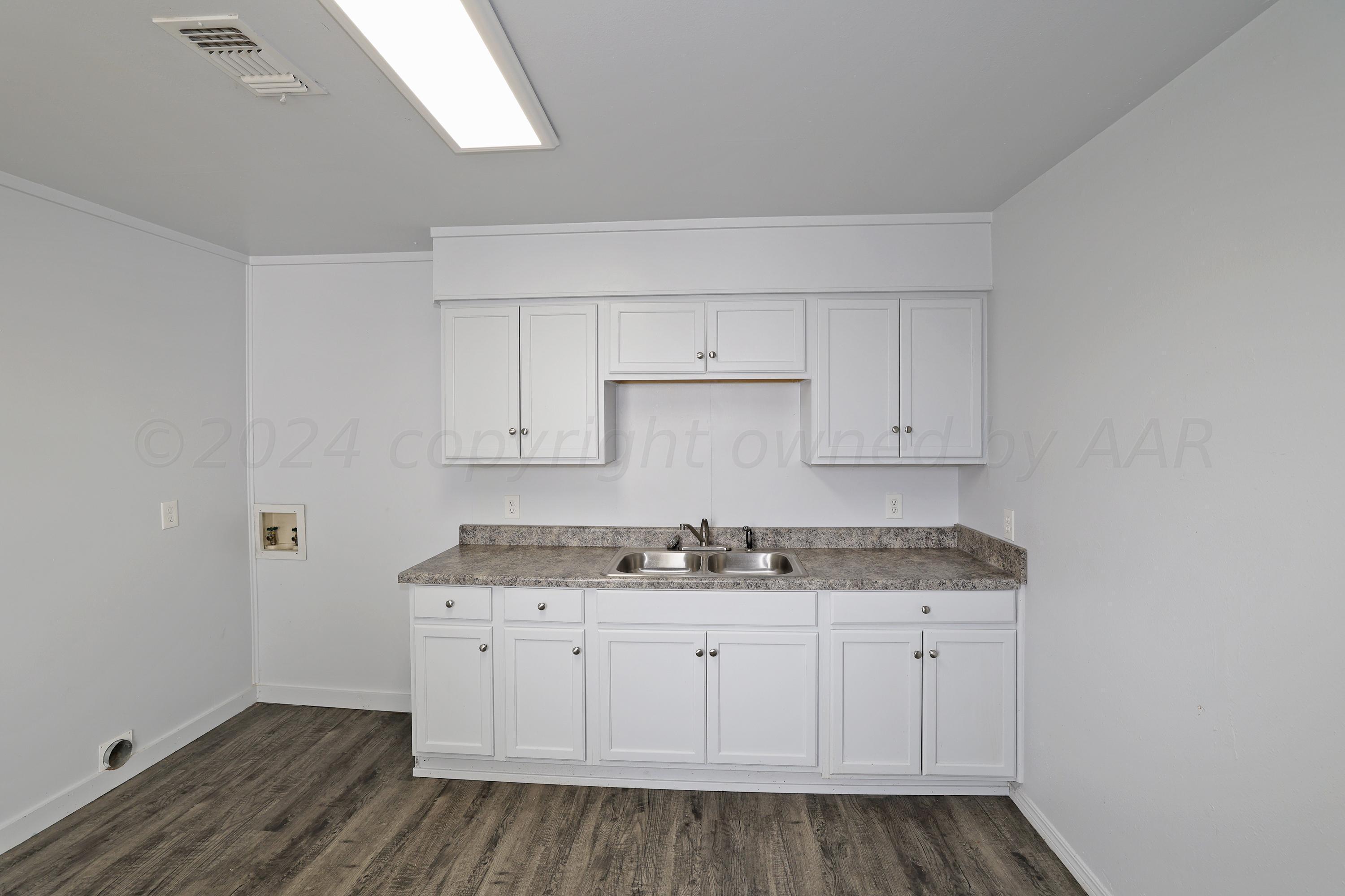 3703 South Monroe Street Amarillo, TX 79110 - Photo 7 of 14 a kitchen with a sink and cabinets