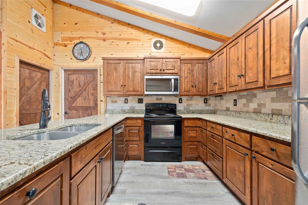 4010 Seneca Circle May, TX 76857 - Photo 21 of 30 a kitchen with stainless steel appliances granite countertop a stove and a sink