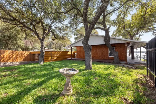 a backyard of a house with table and chairs
