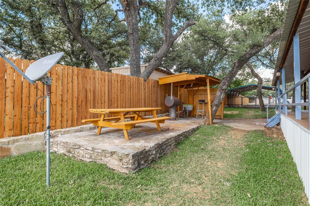 4010 Seneca Circle May, TX 76857 - Photo 9 of 30 an outdoor view of house with backyard and a slide