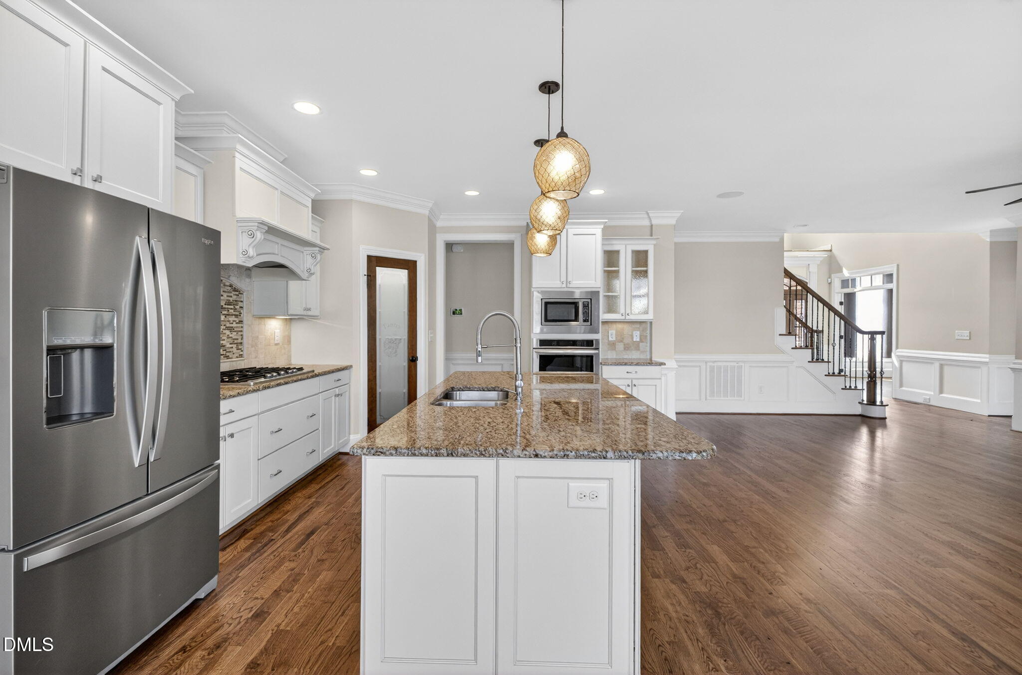 2700 Eastern Star Circle Rolesville, NC 27571 - Photo 12 of 75 a kitchen with stainless steel appliances granite countertop a refrigerator a oven and a sink with wooden floor
