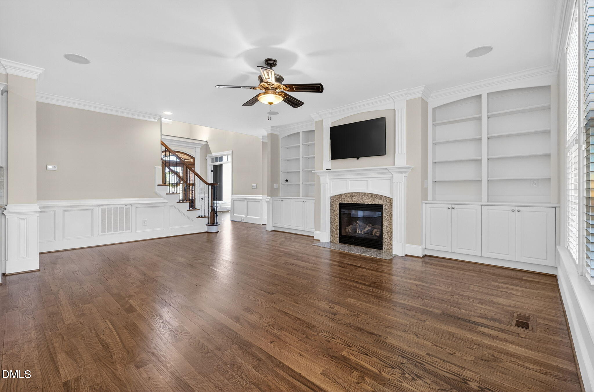 2700 Eastern Star Circle Rolesville, NC 27571 - Photo 15 of 75 a view of a livingroom with a ceiling fan hardwood floor and a fireplace