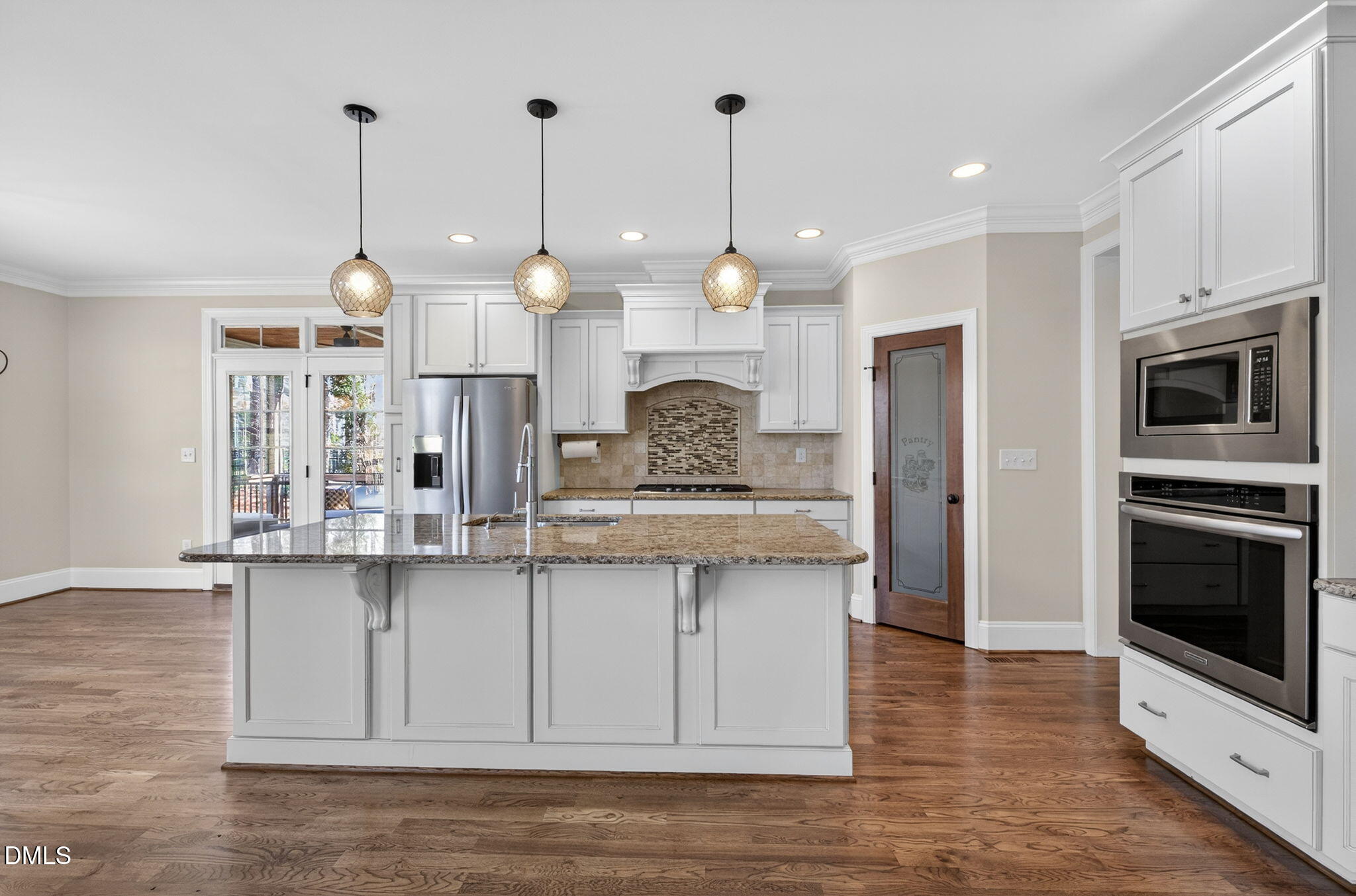 2700 Eastern Star Circle Rolesville, NC 27571 - Photo 10 of 75 a large kitchen with granite countertop a stove a sink a center island a refrigerator and a wooden floor