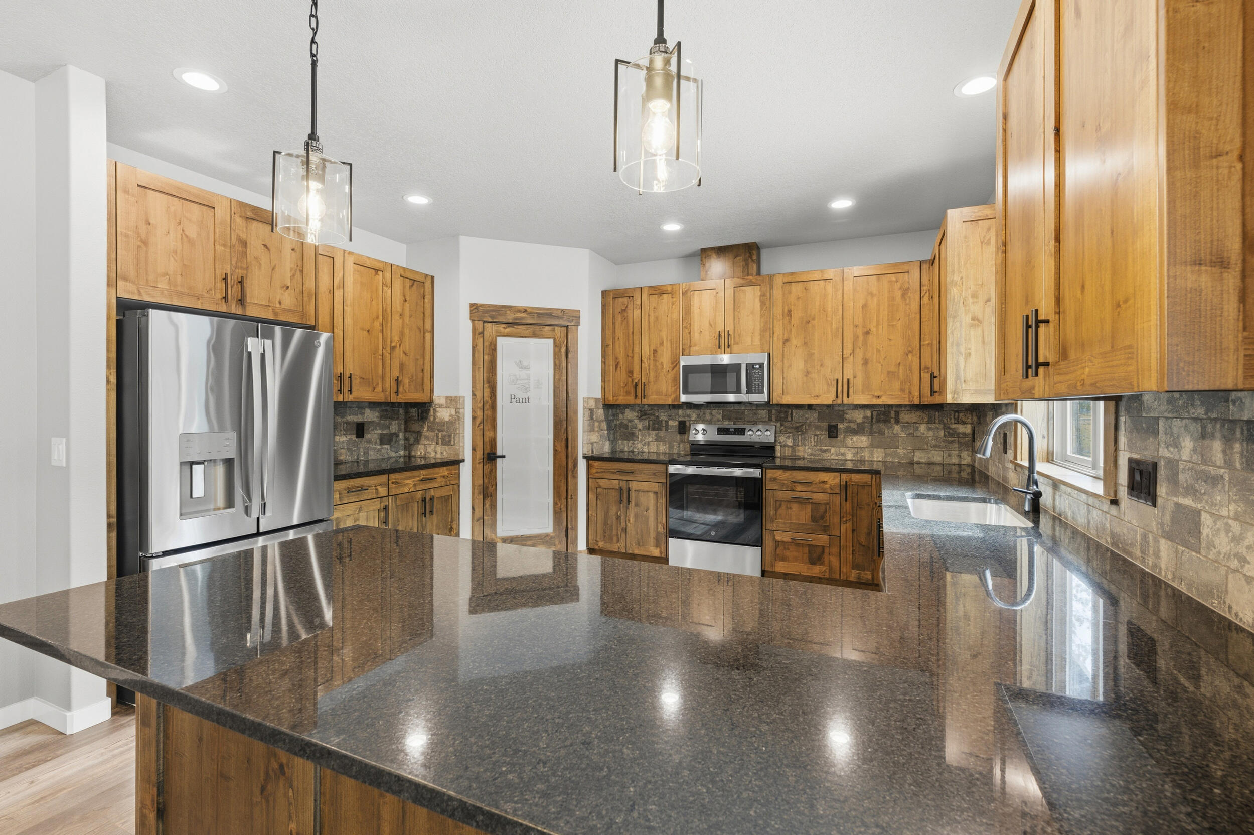 16083 Dyke Road, Unit 9 La Pine, OR 97739 - Photo 10 of 53 a kitchen with stainless steel appliances granite countertop a refrigerator a stove and a sink with granite countertops